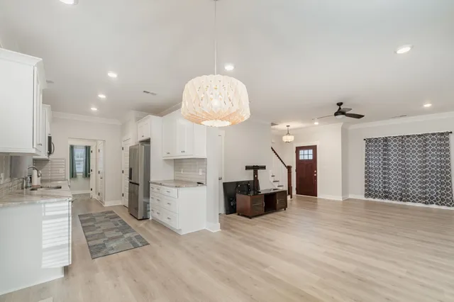 a large kitchen with cabinets and stainless steel appliances