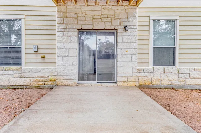 a view of a brick house with a outdoor space