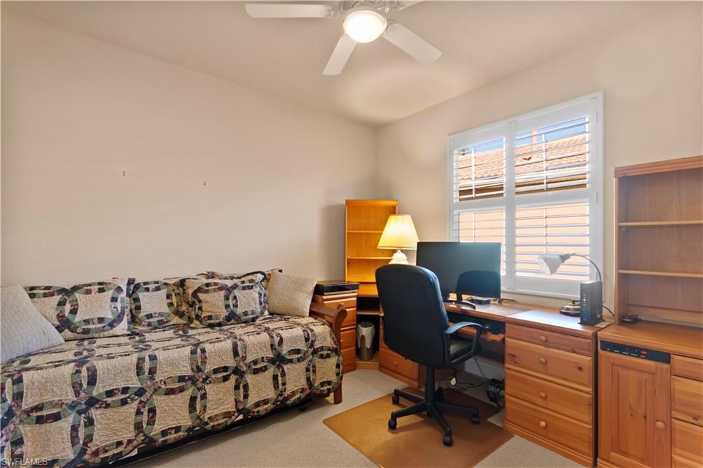 8855 Largo Mar Drive Estero, FL 33967 - Photo 27 of 50 a bedroom with a bed and a desk