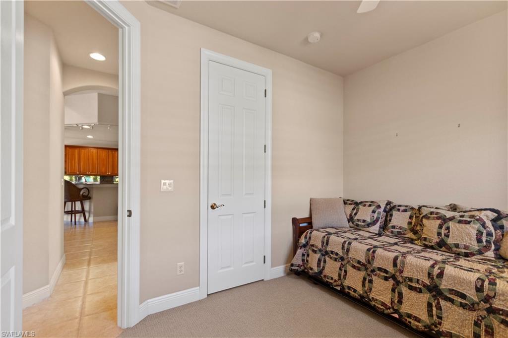 8855 Largo Mar Drive Estero, FL 33967 - Photo 28 of 50 a spacious bedroom with a bed and walk in closet