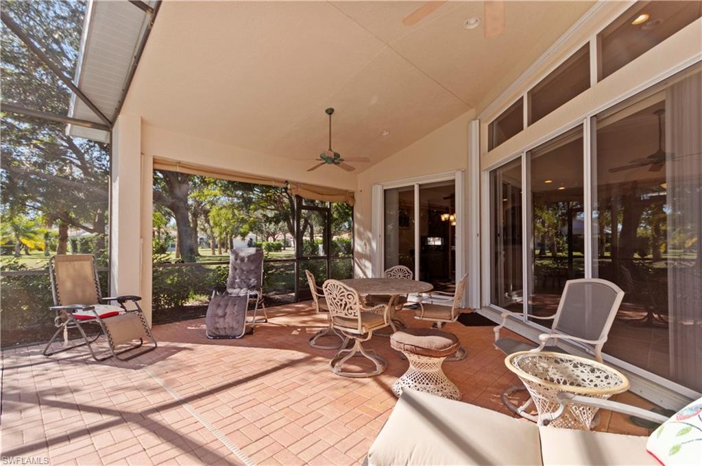 8855 Largo Mar Drive Estero, FL 33967 - Photo 32 of 50 a view of a patio with a dining table and chairs