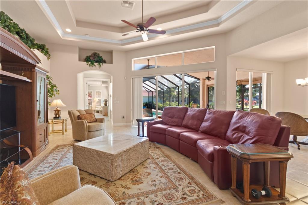 8855 Largo Mar Drive Estero, FL 33967 - Photo 8 of 50 a living room with furniture ceiling fan and a rug