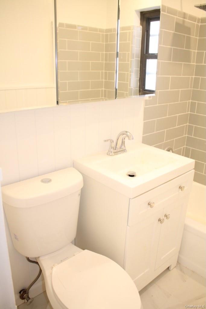 50 White Oak Street, Unit 1C New Rochelle, NY 10801 - Photo 14 of 24 a white toilet sitting next to a bathroom sink