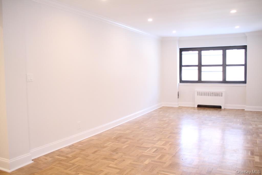 50 White Oak Street, Unit 1C New Rochelle, NY 10801 - Photo 10 of 24 an empty room with wooden floor and windows