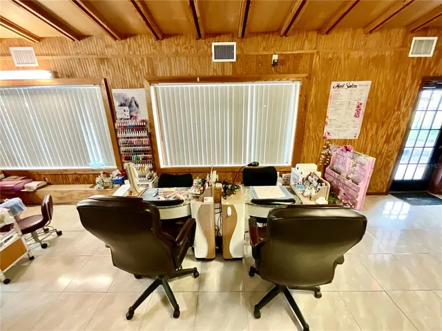 a room with table chairs and wooden floor