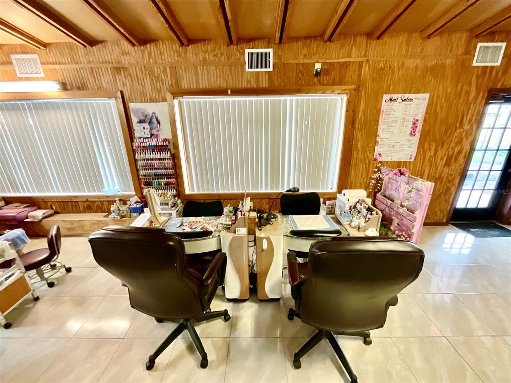 5124 Trouble Creek Road New Port Richey, FL 34652 - Photo 11 of 32 a room with table chairs and wooden floor