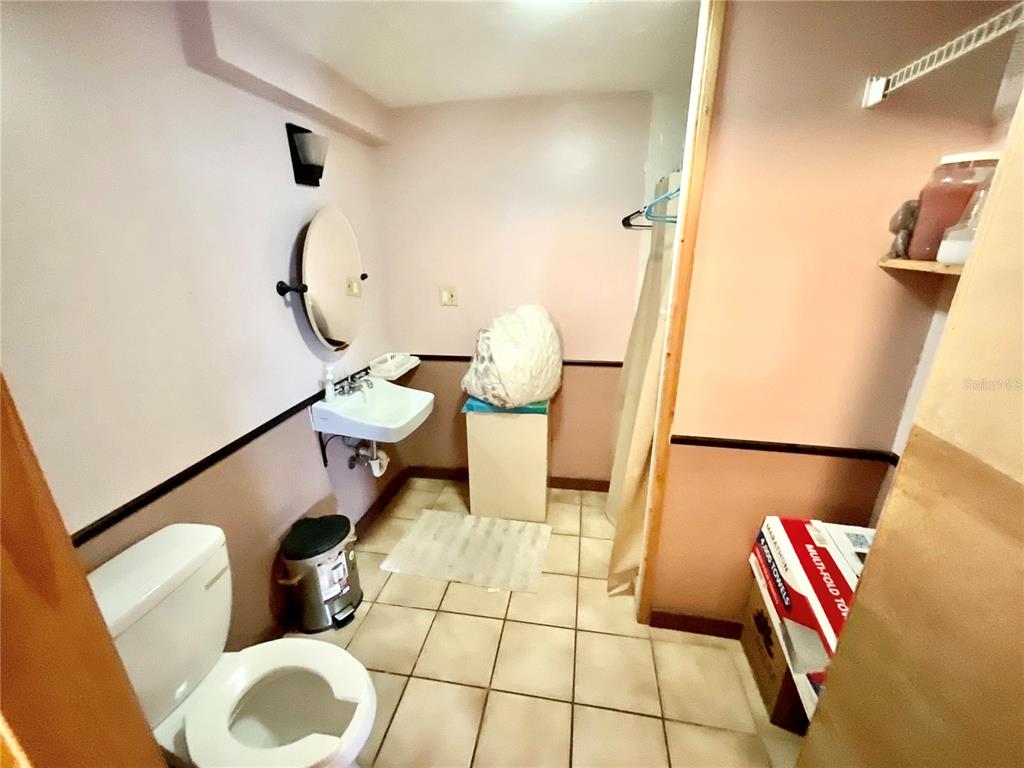 5124 Trouble Creek Road New Port Richey, FL 34652 - Photo 15 of 32 a bathroom with a toilet and a mirror