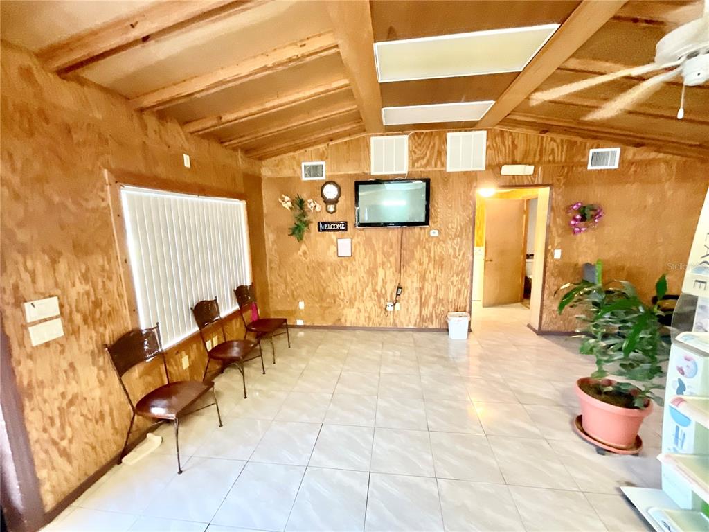 5124 Trouble Creek Road New Port Richey, FL 34652 - Photo 17 of 32 a lobby with furniture and potted plant