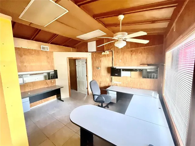 a view of a room with wooden floor and windows