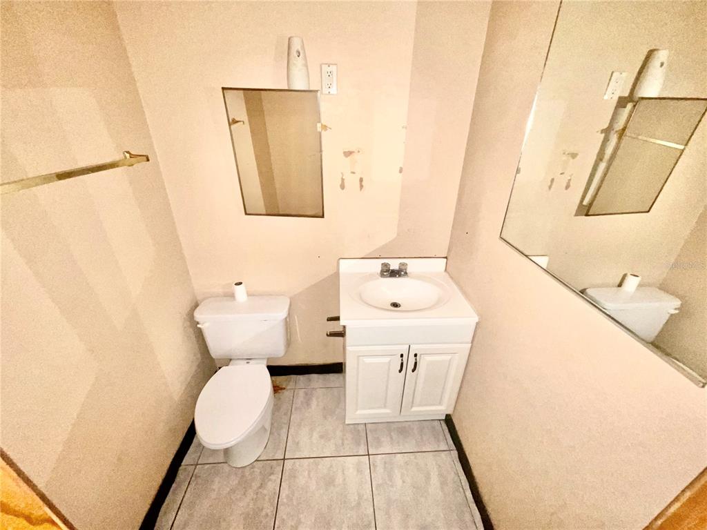 5124 Trouble Creek Road New Port Richey, FL 34652 - Photo 24 of 32 a bathroom with a sink a toilet and vanity