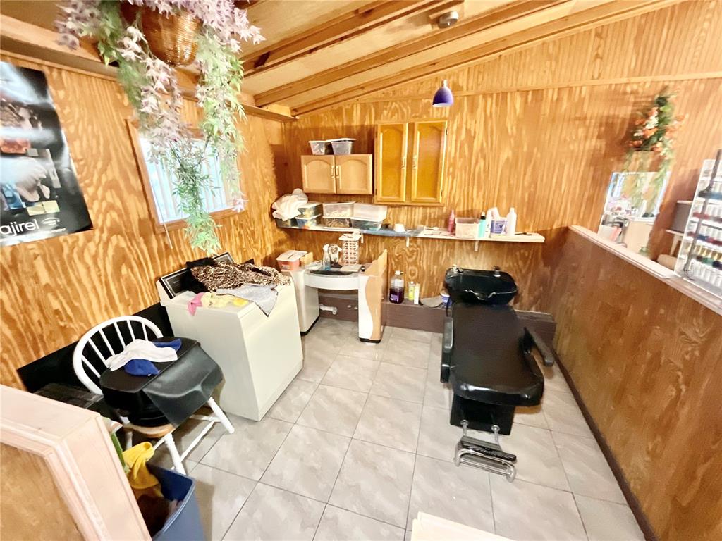 5124 Trouble Creek Road New Port Richey, FL 34652 - Photo 5 of 32 a living room with furniture a rug and white walls