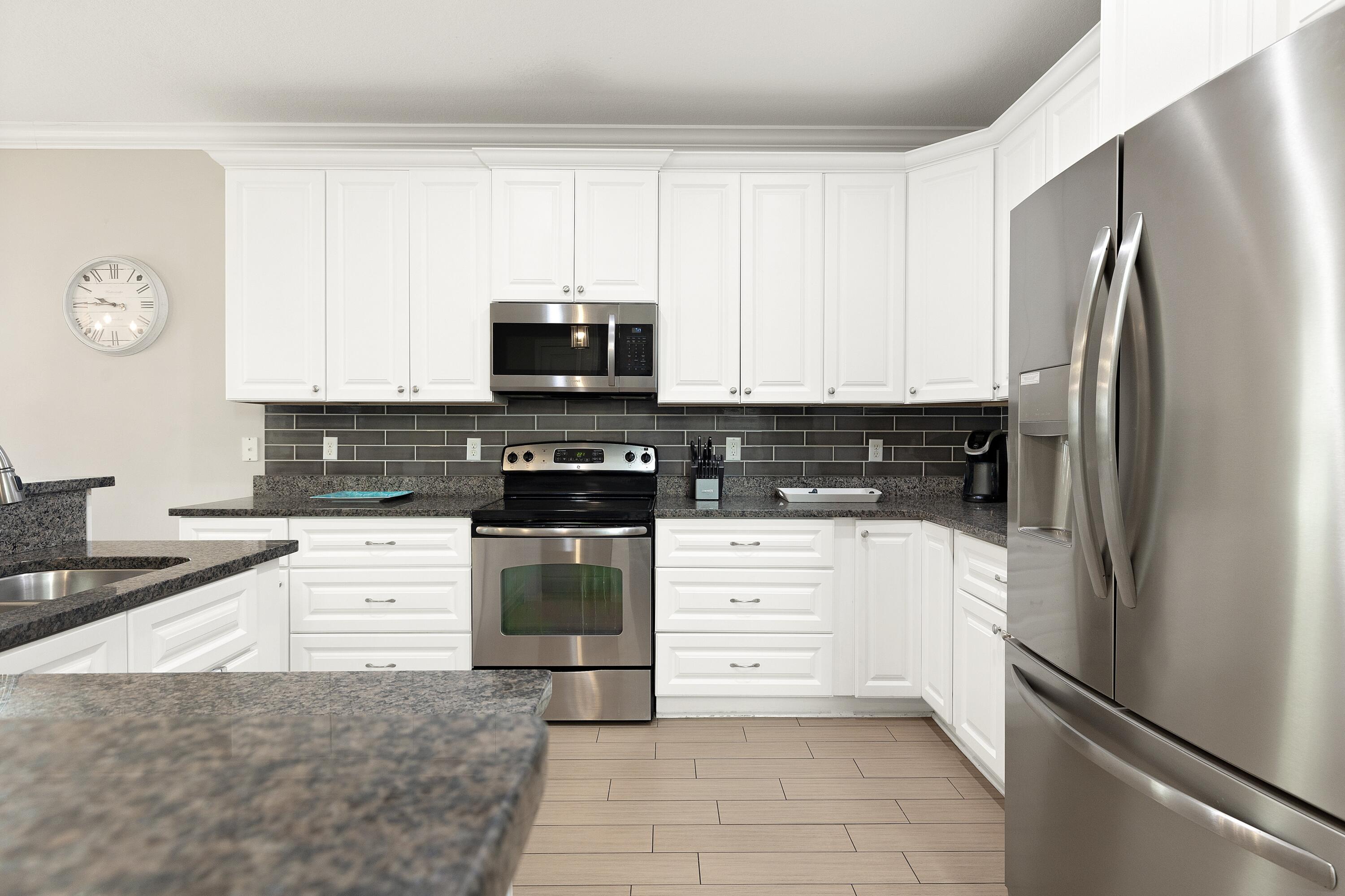 207 Kono Way Destin, FL 32541 - Photo 15 of 45 a kitchen with a refrigerator stove and white cabinets