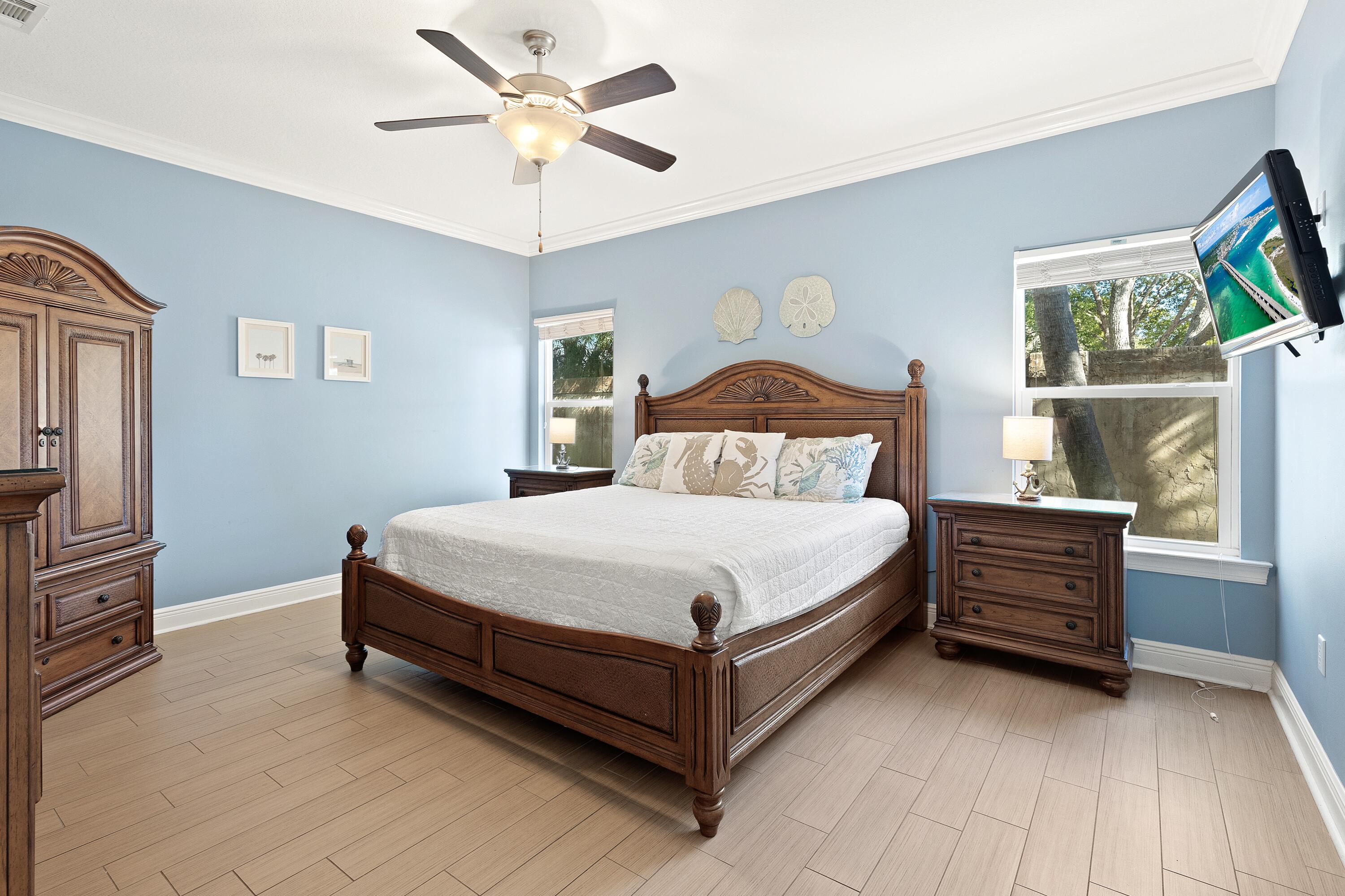 207 Kono Way Destin, FL 32541 - Photo 16 of 45 a bedroom with a bed and a chandelier