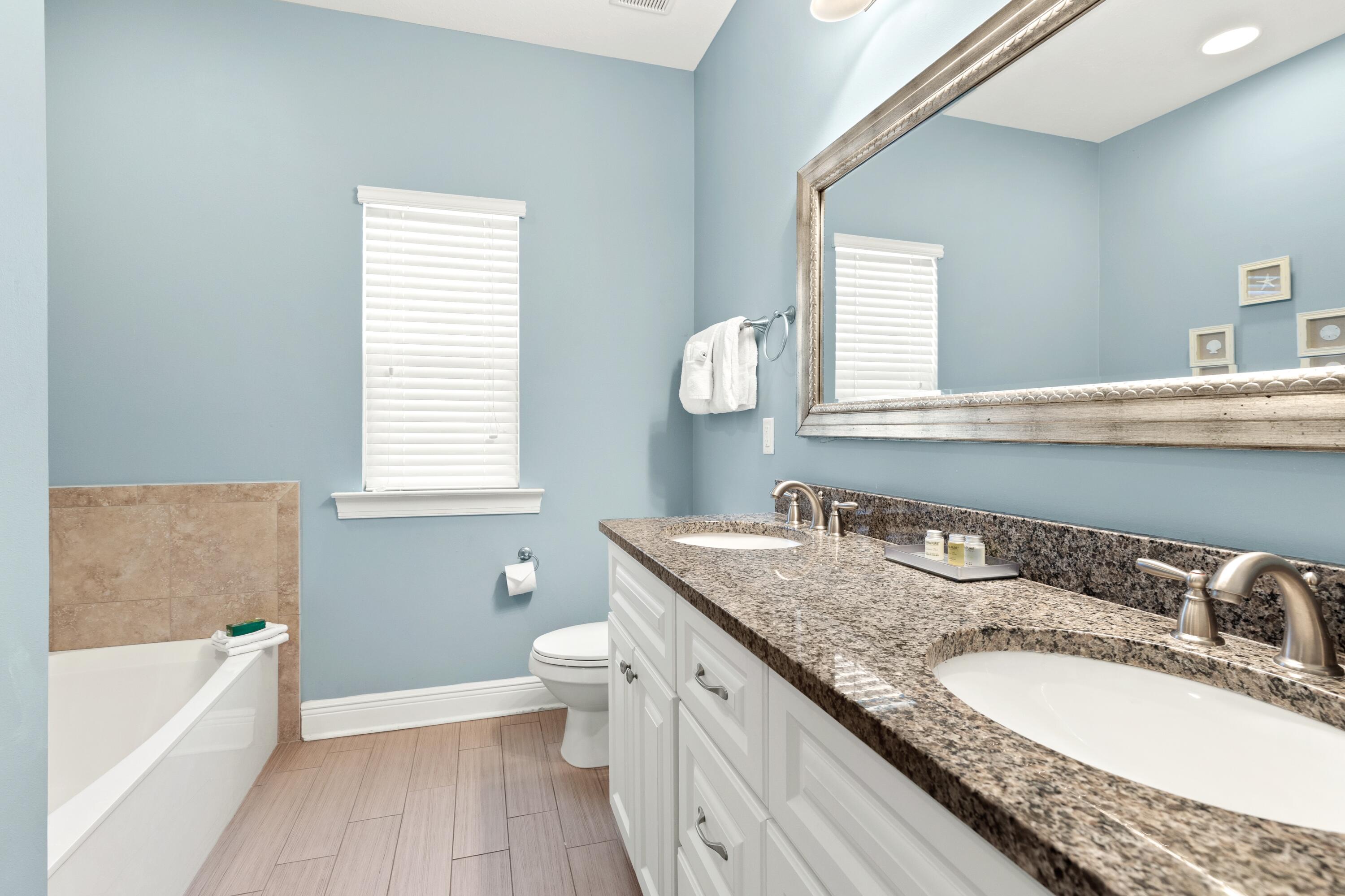 207 Kono Way Destin, FL 32541 - Photo 18 of 45 a bathroom with a granite countertop double vanity sink a mirror and a bathtub