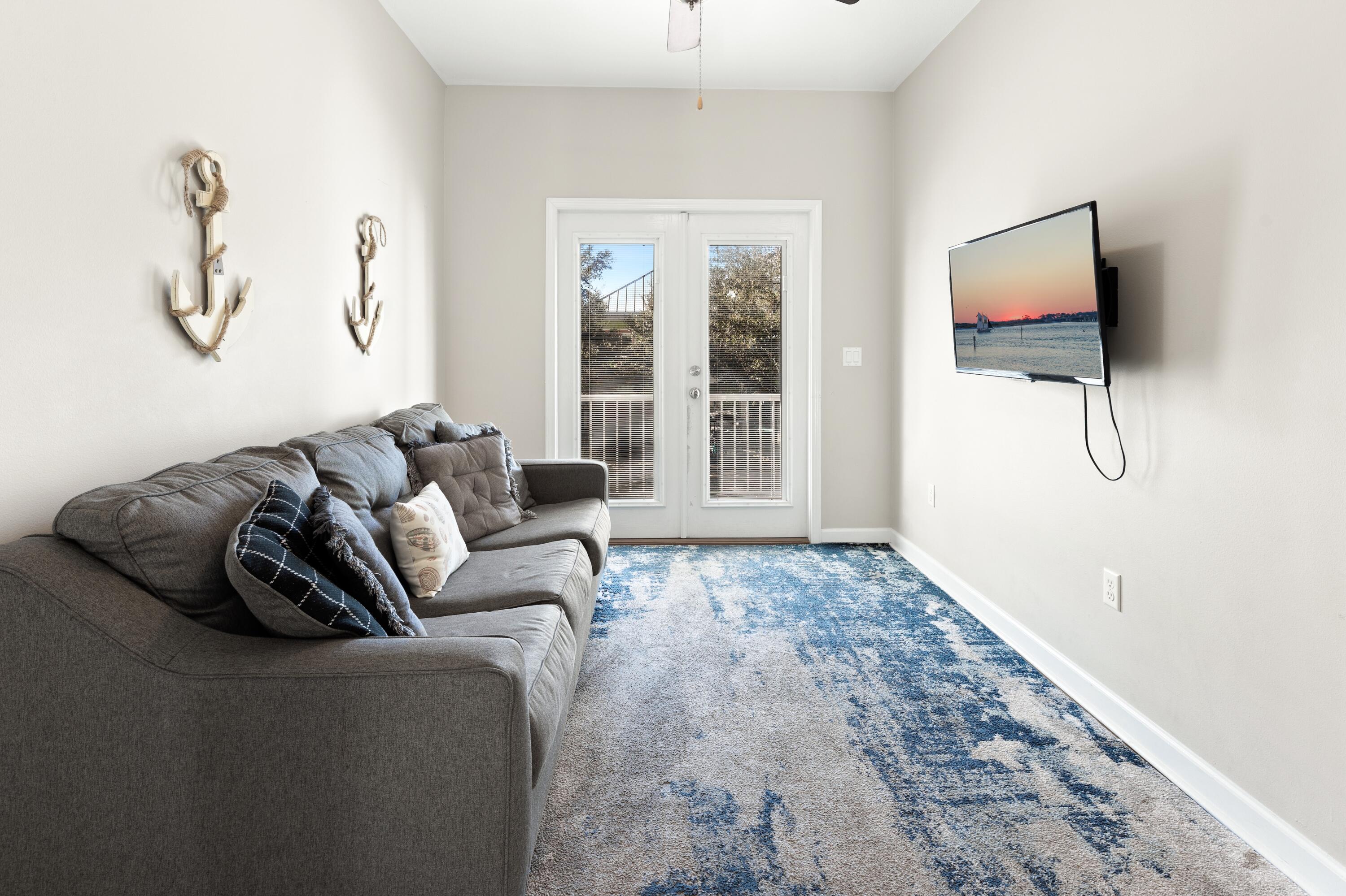 207 Kono Way Destin, FL 32541 - Photo 21 of 45 a living room with furniture a flat screen tv and a window