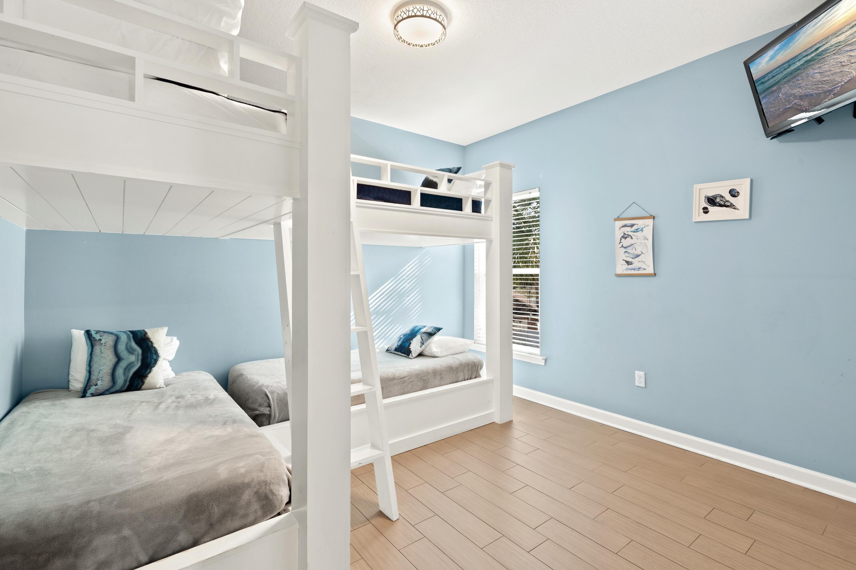 207 Kono Way Destin, FL 32541 - Photo 25 of 45 a bedroom with a bed and wooden floor