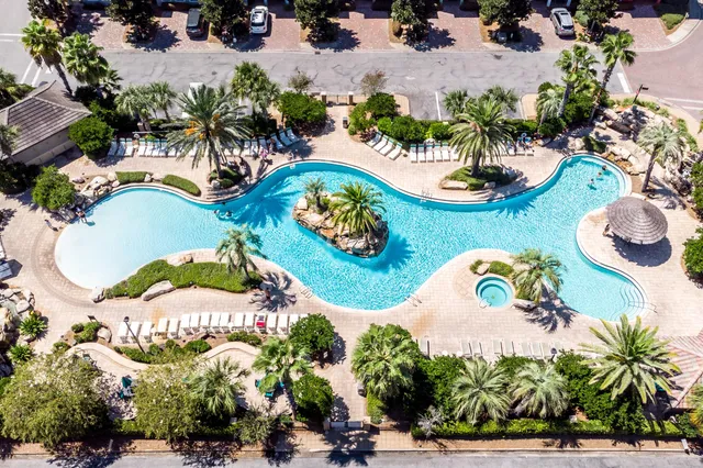 a view of a patio with a table and chairs under an umbrella