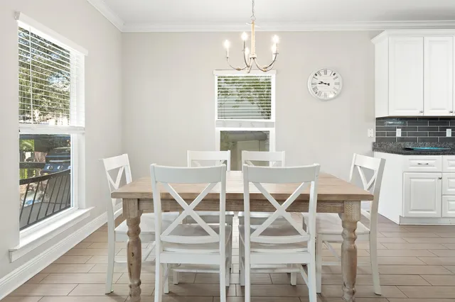 a view of a dining room with furniture and chandelier