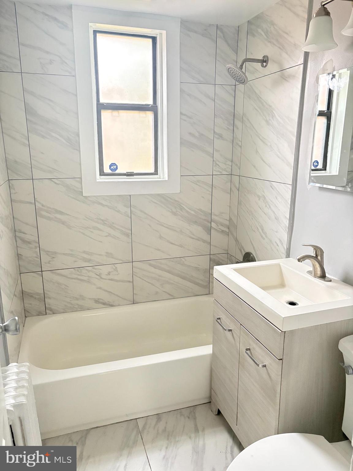 4721 1st Street Southwest, Unit 203 Washington, DC 20032 - Photo 4 of 6 a bathroom with a sink a toilet and bathtub