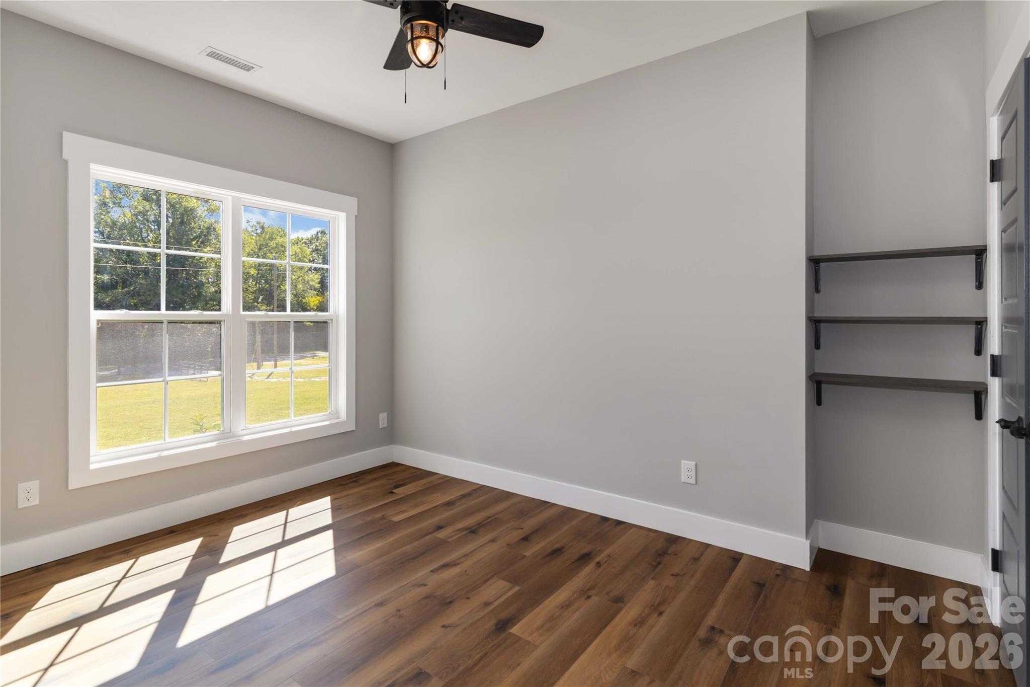 2605 Mt Prospect Road Chester, SC 29706 - Photo 18 of 35 a view of an empty room with a window and wooden floor