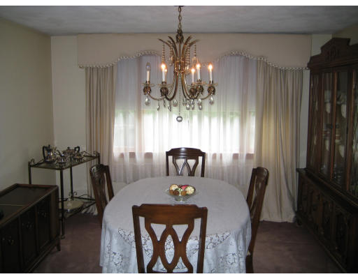 4 Ledgewood Road Woburn, MA 01801 - Photo 11 of 13 a view of a dining room with furniture and chandelier