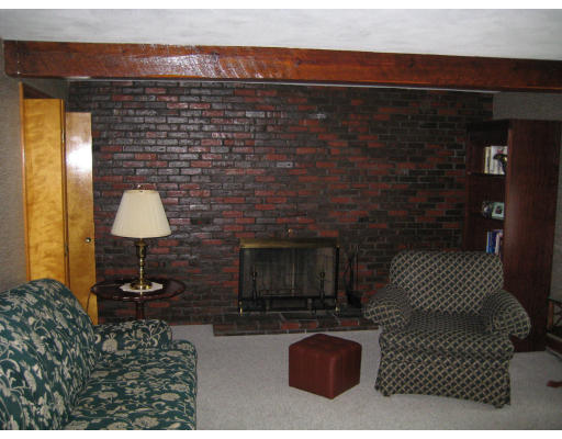 4 Ledgewood Road Woburn, MA 01801 - Photo 13 of 13 a living room with a couch and a fireplace