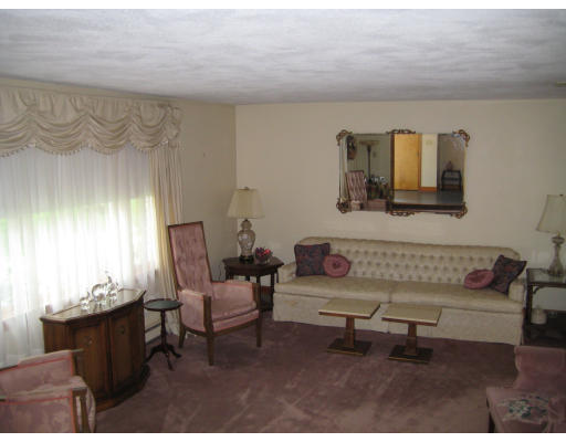 4 Ledgewood Road Woburn, MA 01801 - Photo 8 of 13 a living room with furniture a window and a painting on the wall