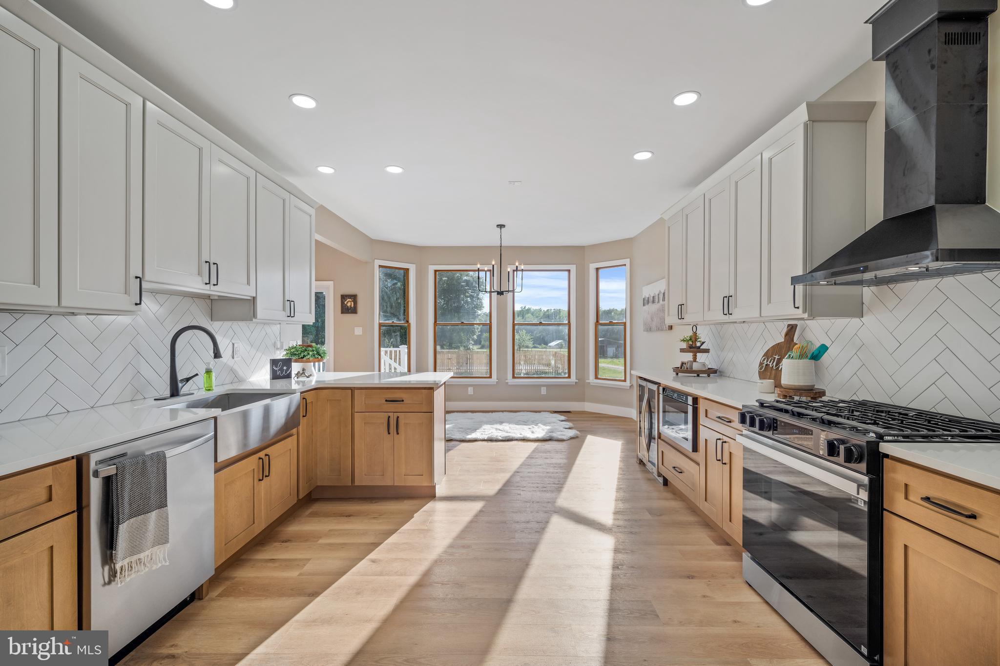 123 West Tomlin Station Road Mickleton, NJ 08056 - Photo 21 of 59 a large kitchen with stainless steel appliances granite countertop a stove a sink and a white cabinets