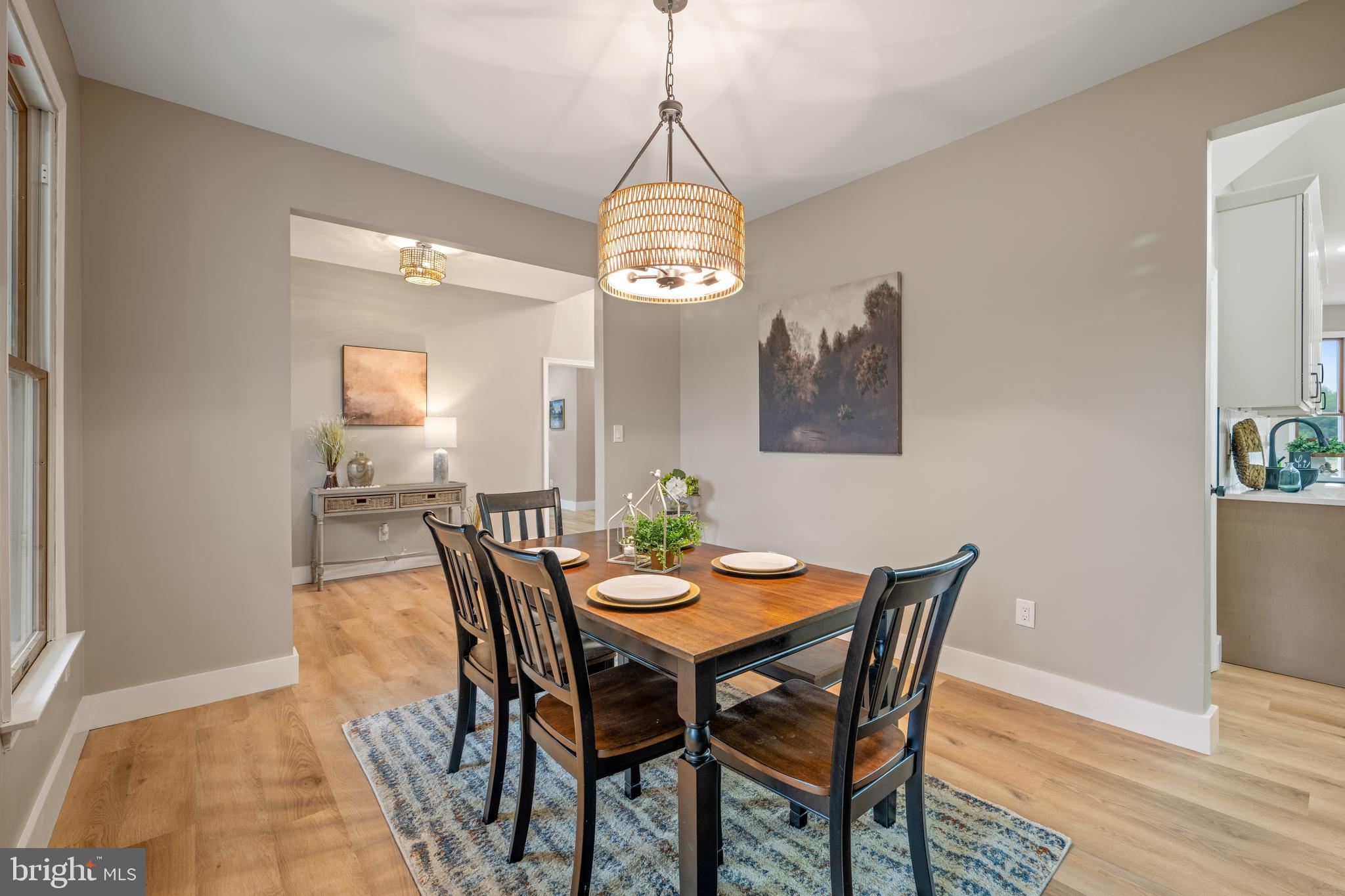 123 West Tomlin Station Road Mickleton, NJ 08056 - Photo 26 of 59 a dining room with wooden floor a chandelier a wooden table and chairs