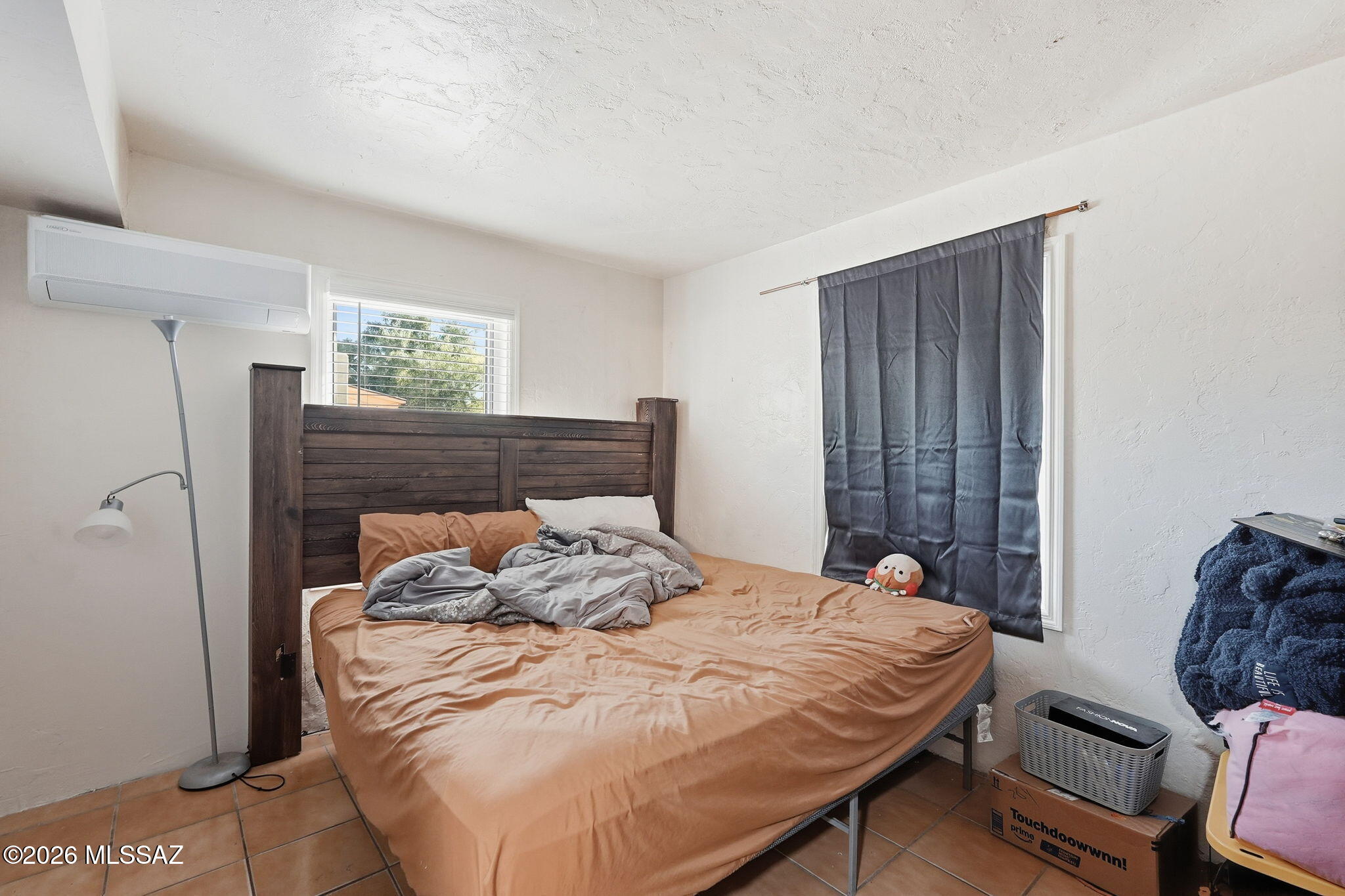 426 East Aragon Road, Unit 1 Tucson, AZ 85756 - Photo 10 of 18 a bed sitting in a bedroom next to a window