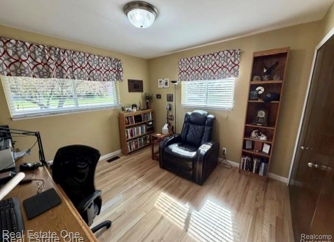 1115 Torpey Road Troy, MI 48083 - Photo 23 of 38 Bed room featuring light wood-finish flooring, two large windows with blinds, a ceiling-mounted light fixture, and warm-toned wall paint