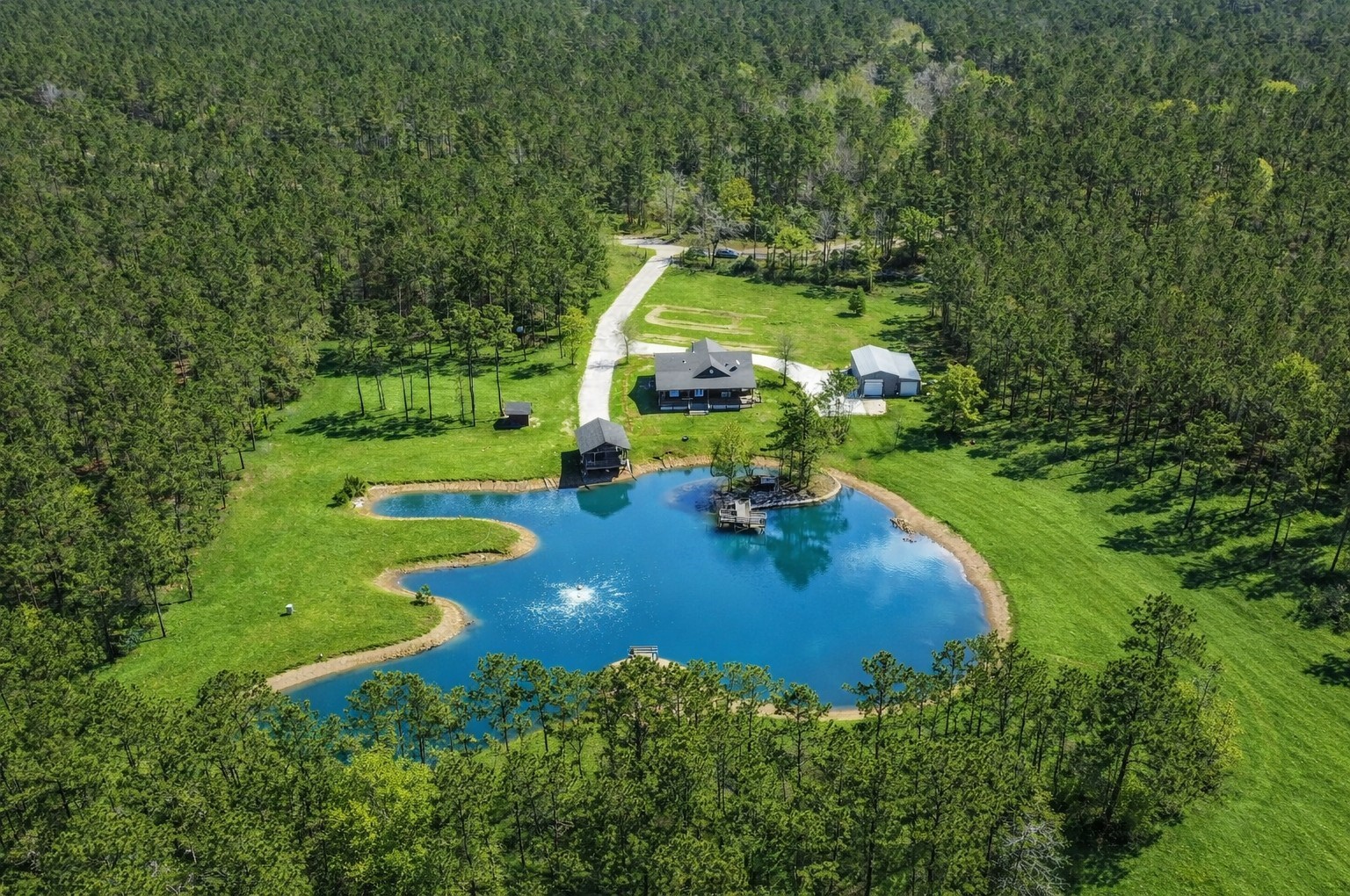 an aerial view of a house with yard swimming pool and outdoor seating
