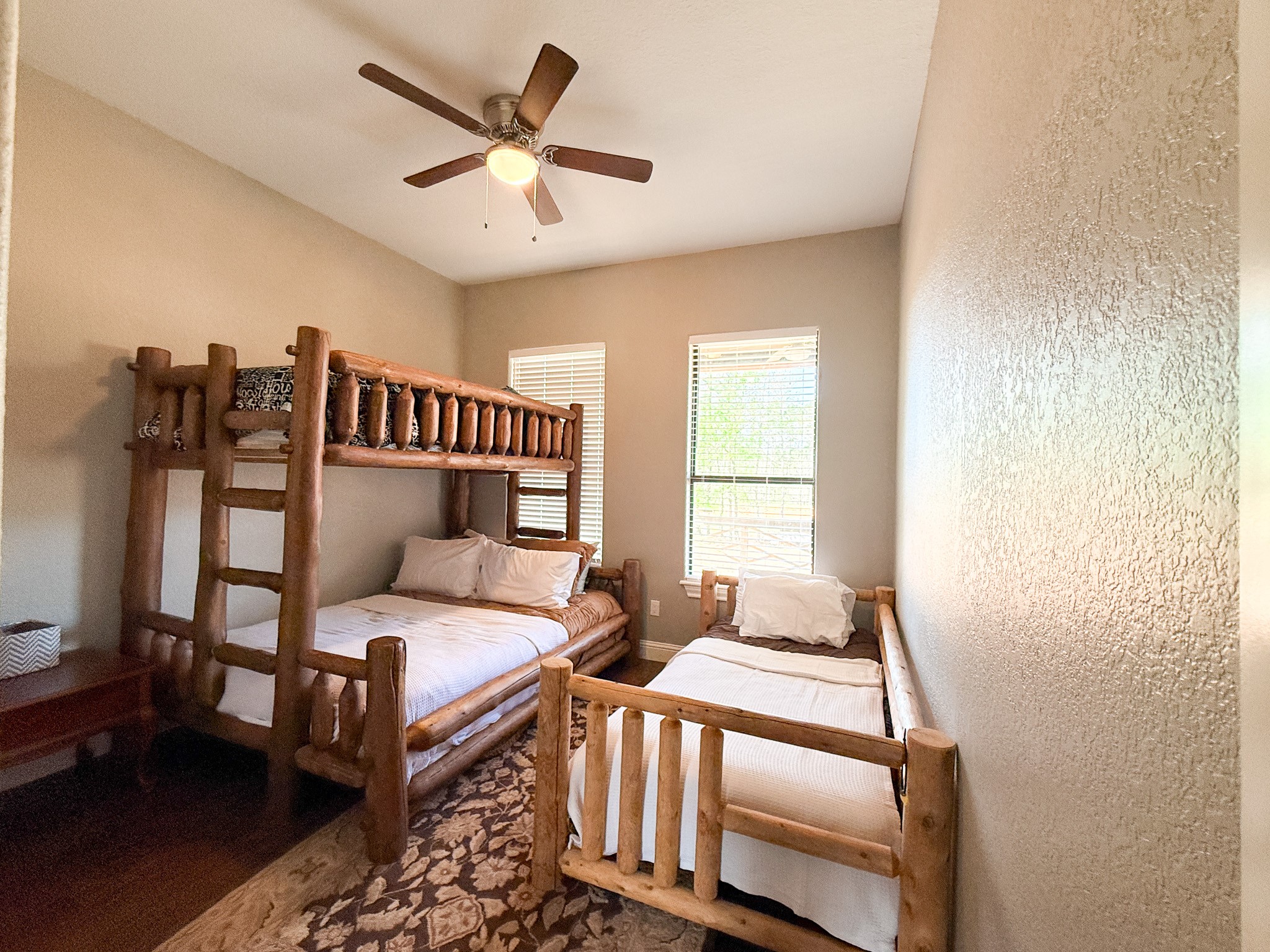 214 Hunters Hill Road Oakhurst, TX 77359 - Photo 13 of 29 a bedroom with two beds and a ceiling fan
