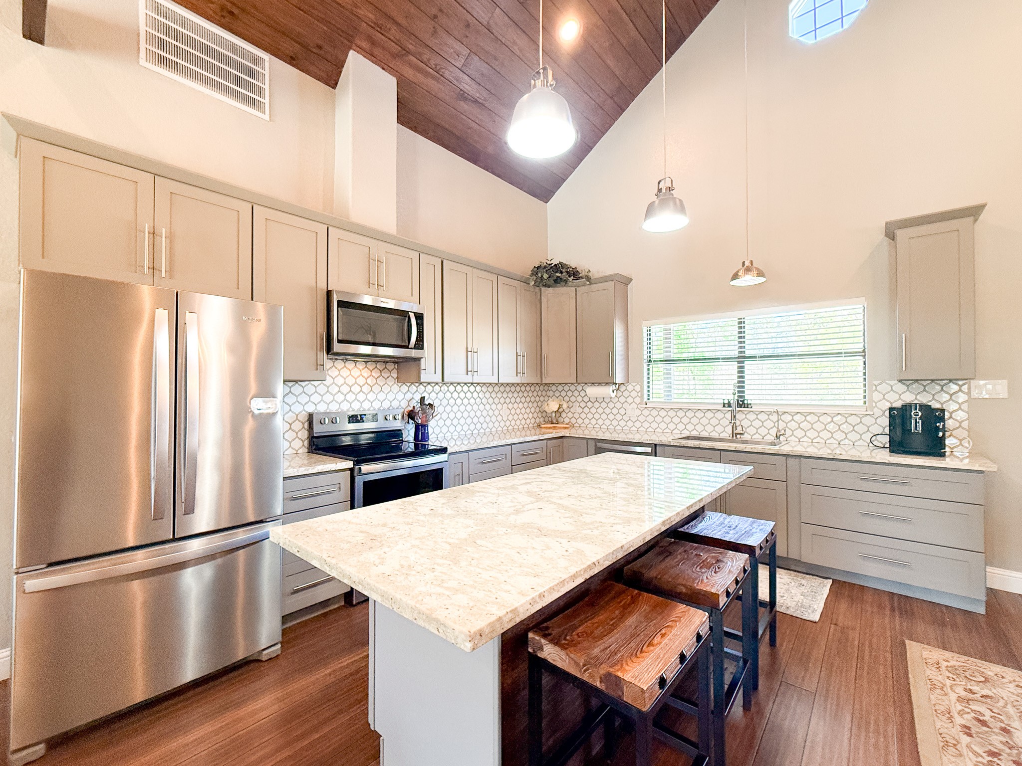 214 Hunters Hill Road Oakhurst, TX 77359 - Photo 10 of 29 a kitchen with a refrigerator a stove a sink and white cabinets with wooden floor