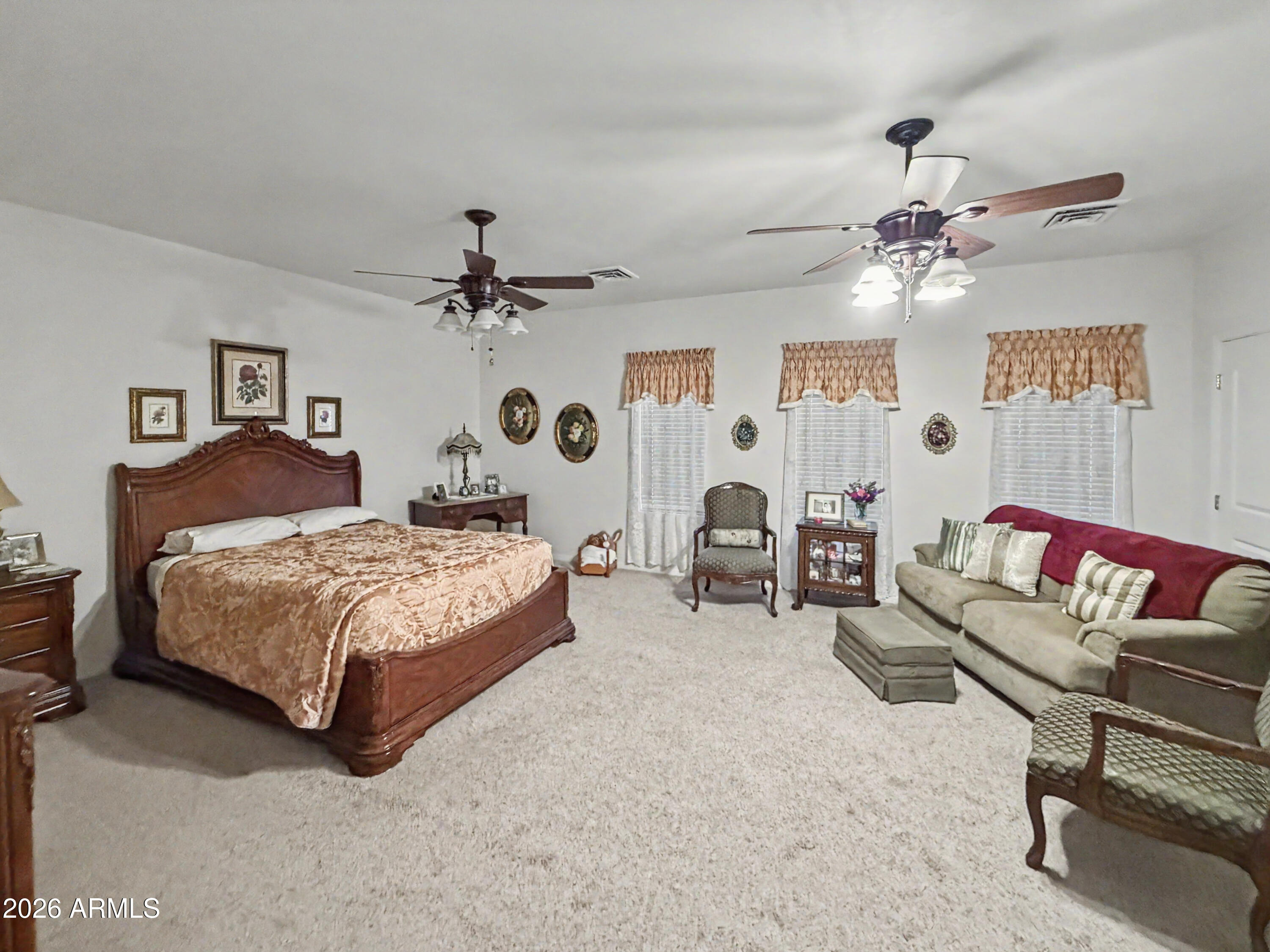 2980 Pine Rim Road Heber, AZ 85928 - Photo 11 of 14 a spacious bedroom with a bed couch chandelier and a window