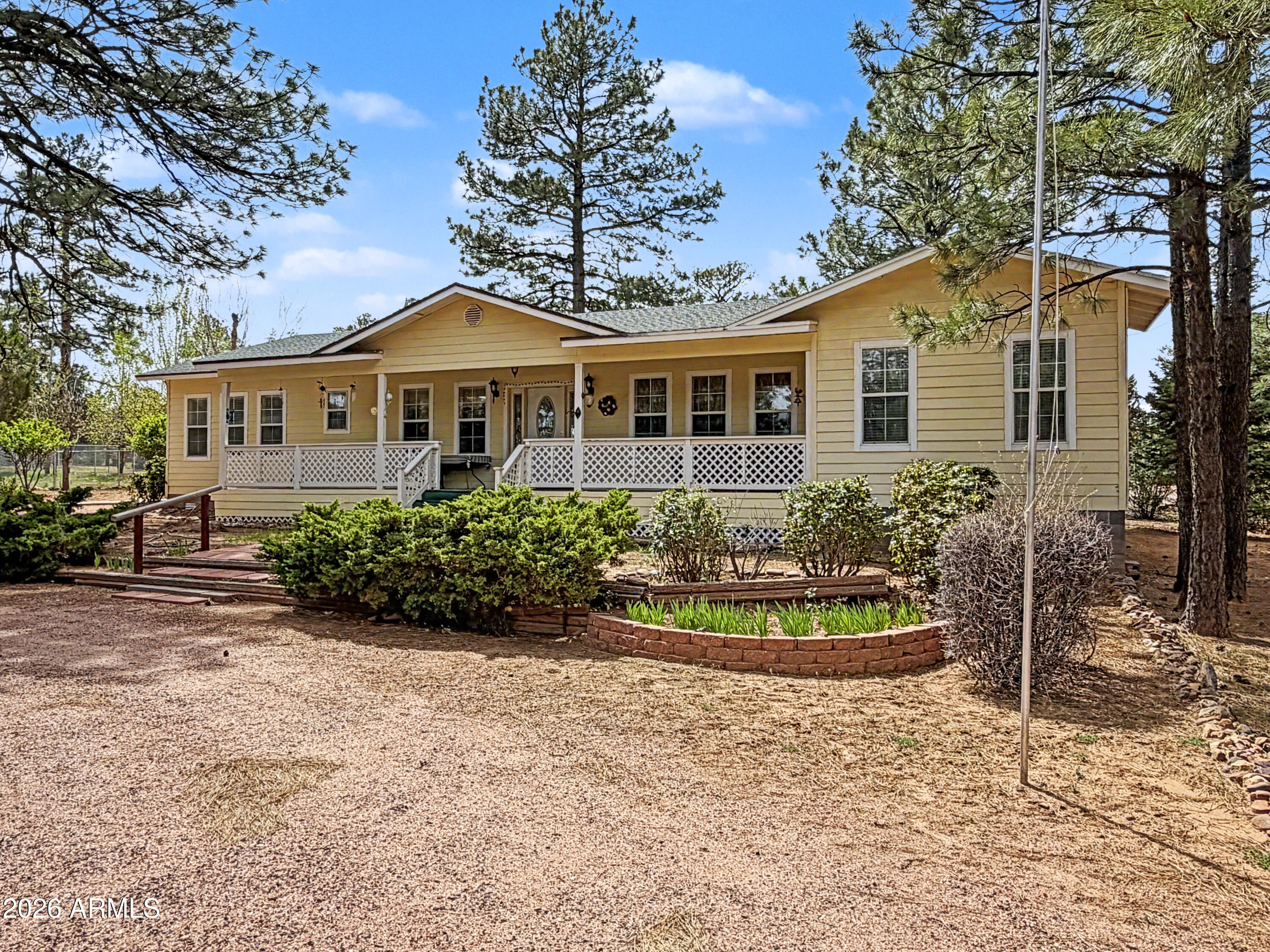 2980 Pine Rim Road Heber, AZ 85928 - Photo 2 of 14 a front view of a house with a yard and potted plants
