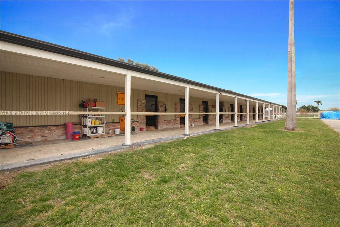 15990 Griffin Road Southwest Ranches, FL 33331 - Photo 12 of 20 a view of a house with a backyard