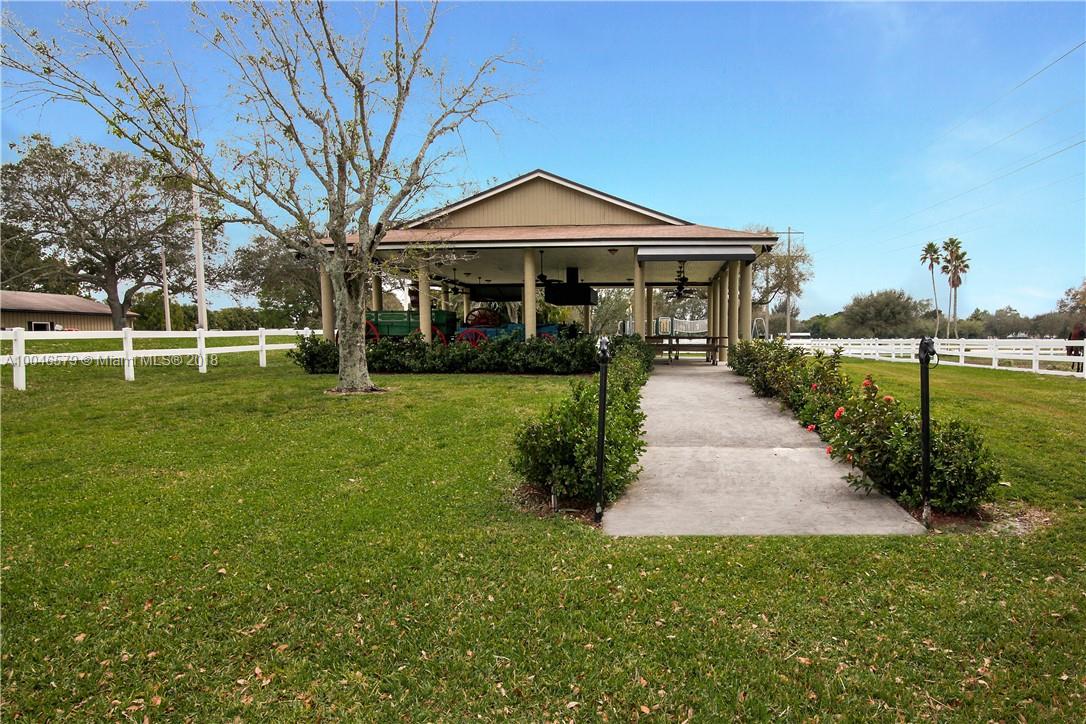 15990 Griffin Road Southwest Ranches, FL 33331 - Photo 15 of 20 a front view of a house with a yard