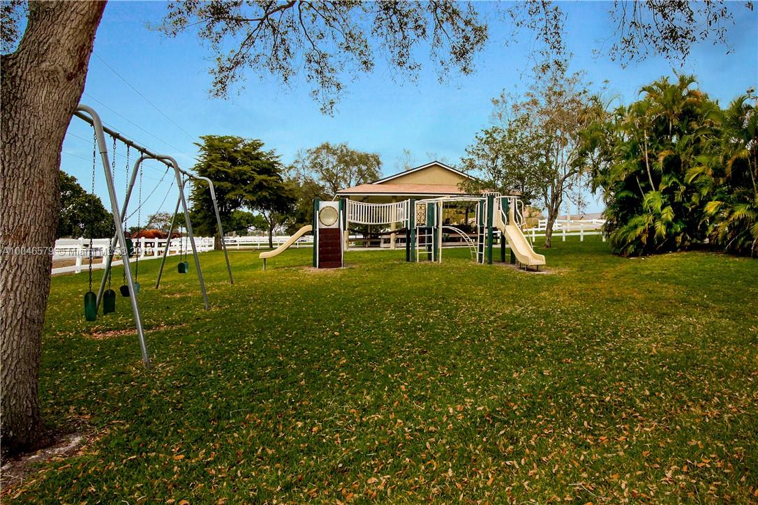15990 Griffin Road Southwest Ranches, FL 33331 - Photo 17 of 20 a view of a house with a yard