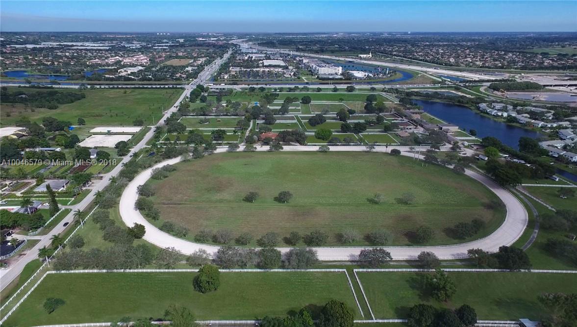 15990 Griffin Road Southwest Ranches, FL 33331 - Photo 2 of 20 an aerial view of a residential houses with outdoor space and swimming pool