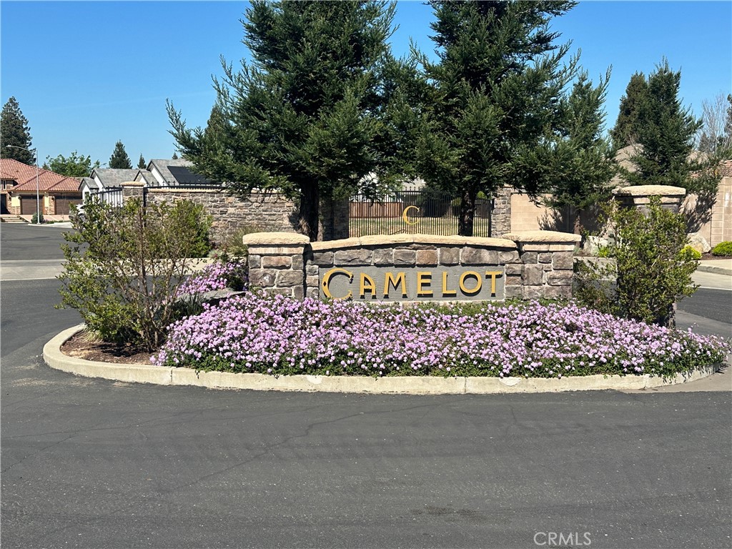 a sign that is sitting in front of flowers