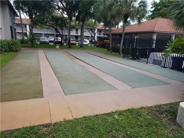 a view of a swimming pool and lounge chairs