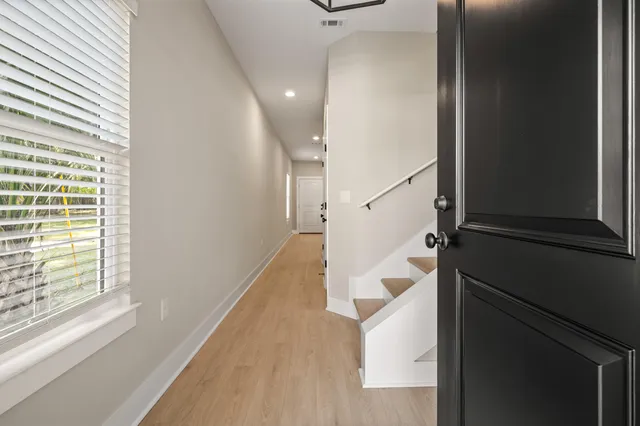 a view of entryway and hall with wooden floor