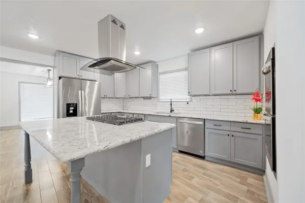 a kitchen with stainless steel appliances granite countertop a sink stove and refrigerator