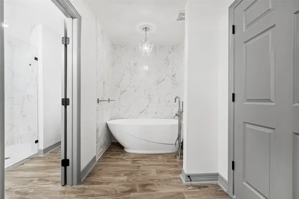 a bathroom with a bathtub and shower