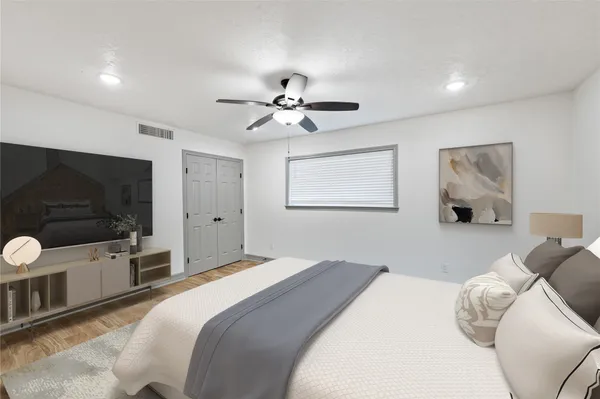 a bedroom with a bed and a flat screen tv