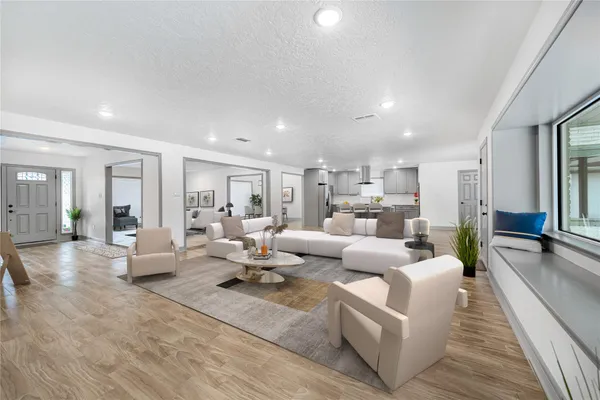 a living room with furniture or couch and a wooden floor