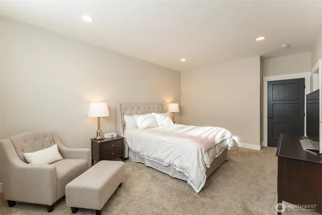 a bedroom with a bed and a couch