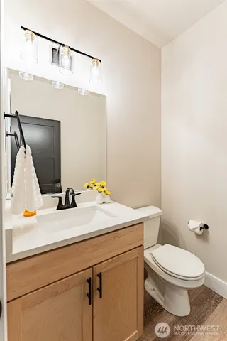 a bathroom with a sink a toilet and mirror