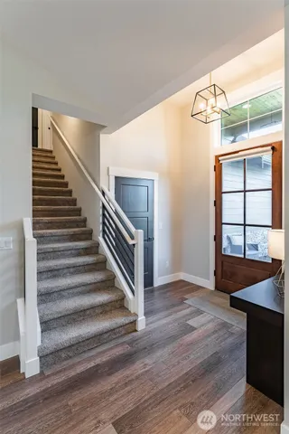 a view of entryway and hall with wooden floor